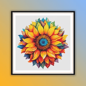 May include: A colourful sunflower with yellow, orange, red, blue and green petals. The sunflower is framed in a black frame.