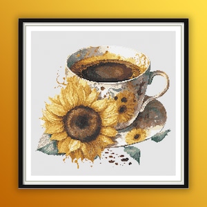 May include: A white coffee cup with brown coffee and a sunflower design, filled with dark brown coffee, on a white saucer with a sunflower design. The cup and saucer are surrounded by a watercolor-style splash of brown coffee.