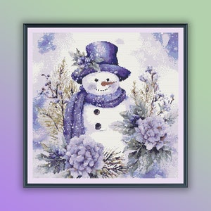 May include: A watercolor painting of a snowman wearing a purple hat and scarf, surrounded by purple flowers and greenery. The background is a light blue with white snowflakes.