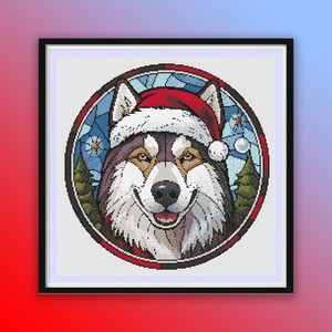 May include: A cross-stitch pattern of a husky dog wearing a red Santa hat. The dog is surrounded by a blue and white stained glass design with snowflakes and pine trees.