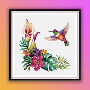 May include: A colorful hummingbird in flight with a white background. The hummingbird is surrounded by tropical flowers and leaves, including a white calla lily, a pink flower, and green leaves.