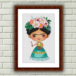 Op de afbeelding: Een ingelijst borduurwerk met kruissteek van een cartoon Frida Kahlo die een bloemenkrans draagt en een penseel en palet vasthoudt.