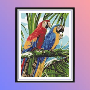 May include: Two parrots perched on a branch in a tropical setting. One parrot is red with blue and yellow accents, the other is blue with yellow accents.