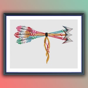 May include: A cross-stitch pattern featuring three colorful arrows with feathers tied together with a yellow cord. The arrows are tied together in the middle and the feathers are spread out on either side. The arrows are pointing in opposite directions.