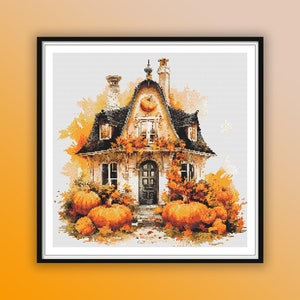 May include: A charming cottage with a black roof and white walls is surrounded by orange pumpkins and autumn foliage. The house has a small porch with a door and windows.