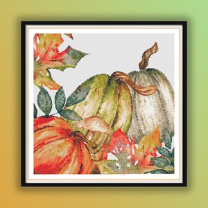 May include: A watercolor painting of three pumpkins with fall leaves. The pumpkins are orange, green, and white. The leaves are red, orange, and green.