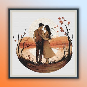 May include: A cross-stitch pattern of a couple standing together in a circular frame. The couple are silhouetted against a sunset with trees and leaves in the background.