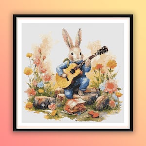 May include: A cross-stitch design of a rabbit playing a guitar, dressed in blue overalls. The rabbit sits on a stone, surrounded by colorful flowers. The artwork is framed in a black border.