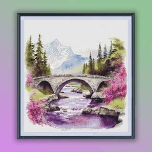 May include: A stone bridge arches over a purple river with a mountain range in the background. Lush green trees and pink flowers line the river banks.