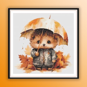 May include: A cute cartoon hedgehog wearing a blue raincoat and holding an umbrella, standing in a pile of autumn leaves.