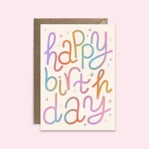 May include: A card with the text "happy birthday" written in a colourful, whimsical font. The letters are in a rainbow gradient.