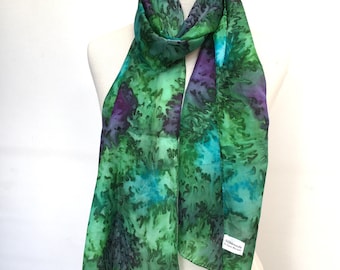 Long silk scarf in emerald green with splashes of turquoise blue and deep purple. A light weight floaty generous 72" (180cm) long silk.
