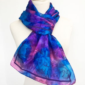 Long silk scarf with an all over dog print in blue, plum pink and red