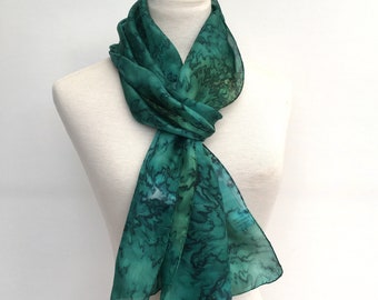 Long pure silk scarf hand-painted in a rich green colour in a water-effect finish. 180cm(72")  long, light weight with hand-rolled edges.