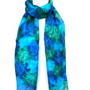 Long silk scarf hand-painted in peacock blue and green. In a mid-weight silk in a generous 68&quot; (170cm) long. With hand-rolled edges.