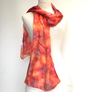 Long hand-painted silk scarf in sunset oranges and also in soft rust brown and olive in a water-effect finish. Generous 68" (170cm) long.