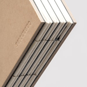 Close-up of basenotes 2333 Kraft sketchbook showing embossed logo and fine hand-stitched spine.