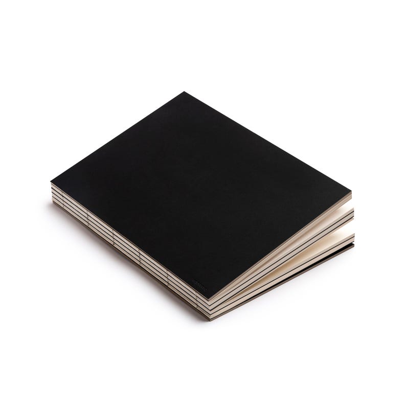 basenotes 2333 Black sketchbook with minimalist matte black cover and visible stitch binding.