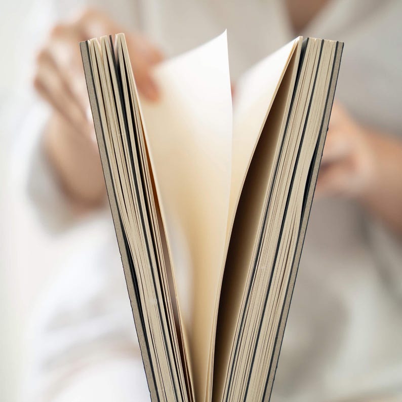 Close-up of pages being turned inside the basenotes 2333 sketchbook showing lay-flat design and textured sheets.