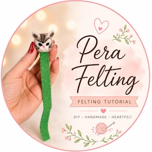 Puede incluir: Un marcapáginas de fieltro hecho a mano con forma de gato y un tallo verde. La cabeza del gato es gris y blanca con detalles en rosa. La imagen también incluye el texto "Pera Felting" y "FELTING TUTORIAL".