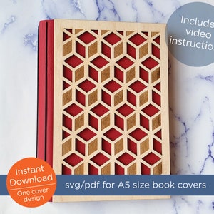 May include: A red and brown wooden book cover with a geometric pattern. The cover is for an A5 size book. The text "svg/pdf for A5 size book covers" is printed below the cover. The text "Includes video instructions" is printed in a blue circle in the upper right corner of the image.