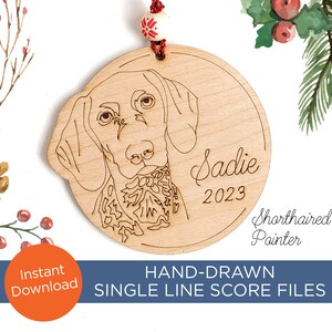 May include: A wooden ornament with a hand-drawn illustration of a German Shorthaired Pointer dog. The ornament is personalized with the name "Sadie" and the year "2023". The text "Shorthaired Pointer" is also included on the ornament.