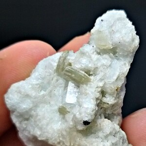 May include: A cluster of white, translucent crystals with green and clear crystals embedded in the matrix.