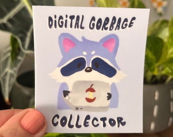 May include: A sticker featuring a cartoon raccoon holding a laptop with the text "DIGITAL GARBAGE COLLECTOR" on a light blue background.