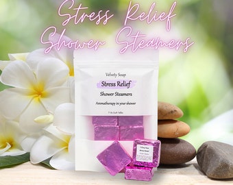 May include: A white pouch with a pink label that reads "Velvety Soap Stress Relief Shower Steamers Aromatherapy in your shower 1 oz Each Tablet". The pouch contains six pink shower steamers.