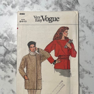May include: A vintage Vogue sewing pattern envelope with a red and brown illustration of two women wearing jackets. The pattern number is 8460 and the size is 6-8-10. The text "Very Easy" is printed on the envelope.