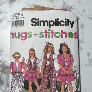 May include: Simplicity pattern 7266 hugs + stitches for girls sizes 7-14. The pattern shows four girls wearing different outfits with vests, skirts, and pants. The pattern is on a white background with a brown paper texture.