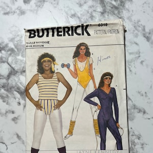 May include: Vintage Butterick sewing pattern 6319 featuring Jayne Kennedy. The pattern shows illustrations of athletic wear, including a striped leotard, a yellow leotard with a white top, and a navy blue jumpsuit. The pattern is size medium.