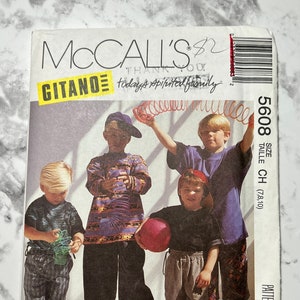 May include: A McCall's sewing pattern for children's clothing, featuring four boys wearing casual outfits. The pattern number is 5608 and the size is listed as "Taille CH (7,8,10)". The pattern is titled "Gitano" and includes the phrase "today's spirited family".
