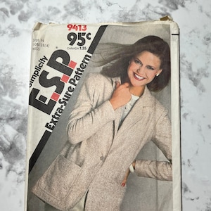 May include: Simplicity pattern number 9413, Extra-Sure Pattern, for a blazer. The pattern is for sizes 10, 12, and 14. The pattern is priced at 95 cents. The pattern shows a woman wearing a beige blazer with a pocket on the left side.