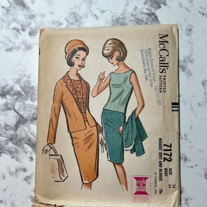 May include: Vintage McCall's sewing pattern for a misses' suit and blouse. The pattern is for sizes 14, 34 bust, and 7 1/2. The pattern shows a woman wearing a brown suit with a matching hat and a woman wearing a turquoise skirt and a white sleeveless blouse.