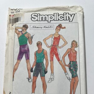 May include: A sewing pattern for a women's athletic outfit. The pattern includes a tank top, shorts, and a headband. The pattern is from Simplicity and is designed by Sherry Halt. The pattern is for size small. The pattern is called "Surf Club".