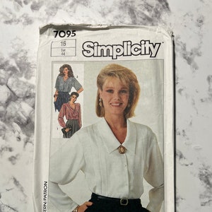 May include: Simplicity sewing pattern number 7095 for a white blouse with a collar and long sleeves. The pattern is for size 16, European size 44.