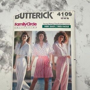 May include: A sewing pattern for women's clothing, featuring three models wearing different styles of tops and trousers. The pattern is from Butterick, the Family Circle Collection, and is for sizes 12-14-16. The pattern is labelled "Very Easy/Tres Facile" and "Fast & Easy".