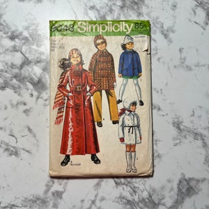 May include: Simplicity sewing pattern number 9048 for a girl's coat. The pattern includes four different styles of coats, including a red maxi-length coat, a plaid coat, a blue coat, and a white fur-trimmed coat. The pattern is for sizes 14, with a 32 inch bust and 26 1/2 inch waist.