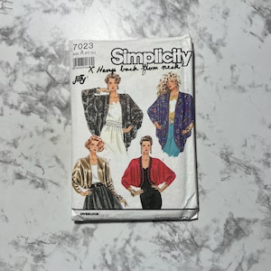 May include: A Simplicity sewing pattern, size A (PT-XL), with illustrations of women's jackets. The pattern includes the text "7023" and "Jiffy". The jackets are in various colours and styles.