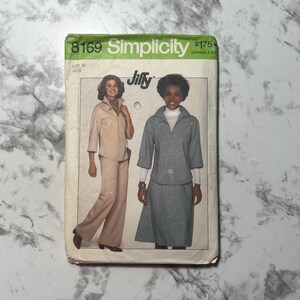 May include: Vintage Simplicity sewing pattern, size 16, featuring two women's outfits. One outfit is a beige pantsuit, and the other is a gray skirt suit. The pattern is labeled "Jiffy" and includes the price.