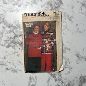 May include: Vintage Butterick sewing pattern, size 8, featuring a red hooded coat and a plaid jacket. The pattern includes the text "FAST and EASY" and the number "5635".