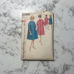 May include: Vintage Simplicity sewing pattern, number 4260, featuring illustrations of women's coats in blue and pink. The pattern includes sizing information and the text "Printed Pattern 65c". The cover is aged with wear.