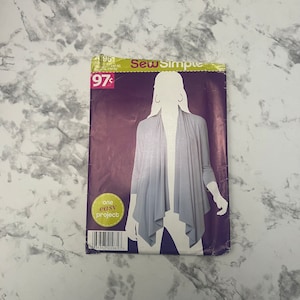 May include: Sew Simple pattern #4961 for a grey cardigan with a draped front. The pattern is labelled "one easy project" and costs 97 pence.