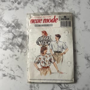 May include: A sewing pattern for a blouse with a multi-size pattern. The pattern is called "neue mode" and the pattern number is 20659. The pattern includes three different styles of blouses. The pattern is for sizes 38-48-12-22.