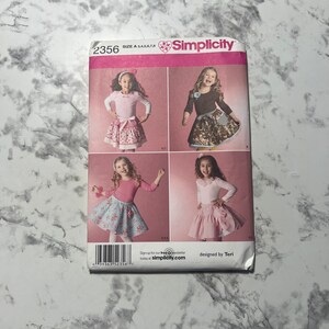 May include: Simplicity sewing pattern number 2356 for sizes 3-8. The pattern includes instructions for making a skirt with a variety of fabric options. The pattern is designed by Teri.