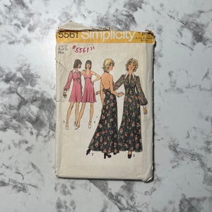 May include: Vintage Simplicity sewing pattern 5561. The pattern envelope features illustrations of dresses with various styles, including a halter dress and a floral print maxi dress. The size is 12, bust 34 inches.