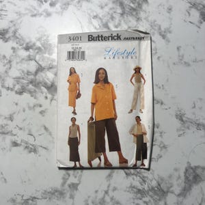 May include: A Butterick sewing pattern titled "Lifestyle Wardrobe" featuring illustrations of women's clothing. The pattern includes designs for a skirt suit, trousers, and a jacket. The pattern number is 3401.