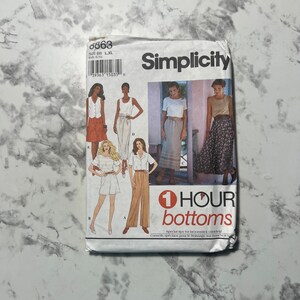May include: Simplicity sewing pattern number 6863 for 1-hour bottoms. The pattern includes four different skirt styles, including a floral print skirt, a solid skirt with a belt, and a skirt with a ruffle.