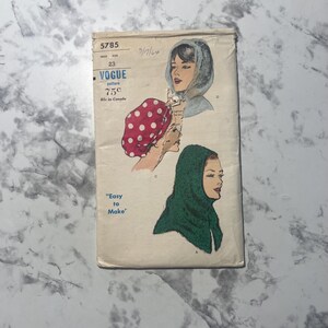 May include: A vintage Vogue sewing pattern envelope numbered 5785, featuring illustrations of head coverings. The envelope displays a red and white polka dot headscarf, a light blue hood, and a dark green hood, with the text Easy to Make.